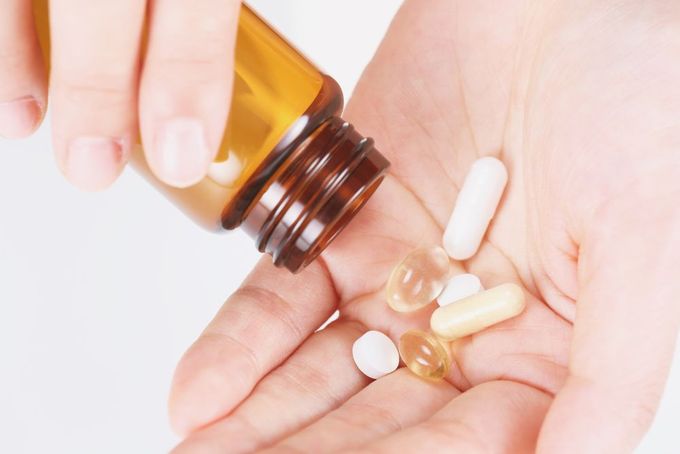 a person holding a bottle of pills in their hand