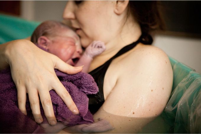 a woman holding a baby in her arms