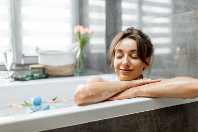 a woman sitting in a bathtub with her arms crossed