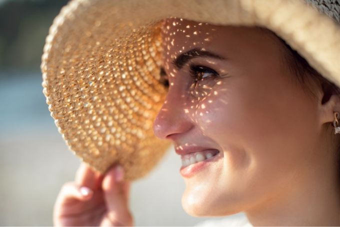 a woman wearing a straw hat and smiling