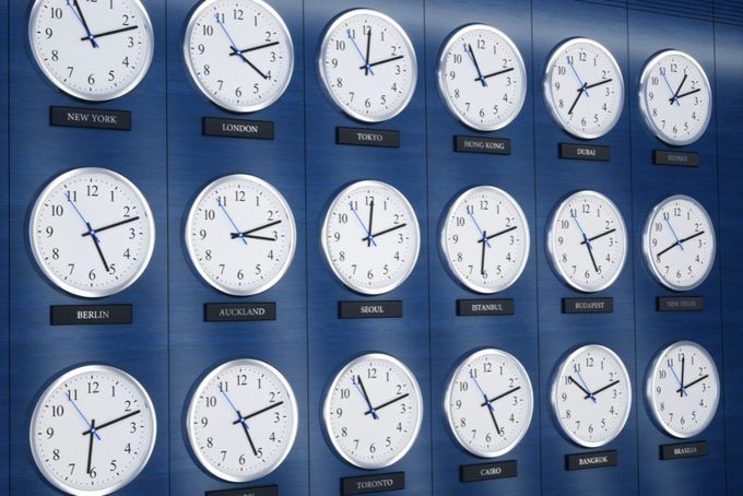 a bunch of clocks that are on a wall