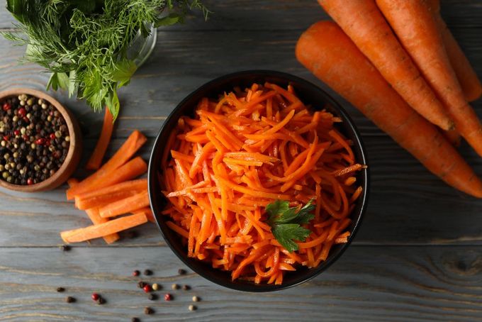a bowl of carrots and other vegetables on a table