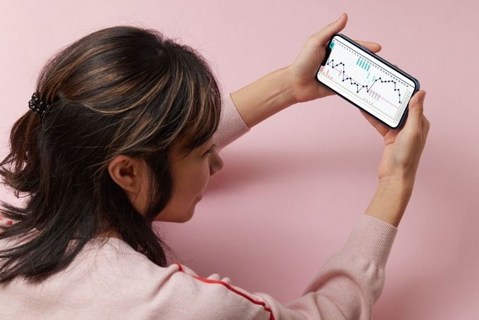 a woman holding a cell phone up to her face