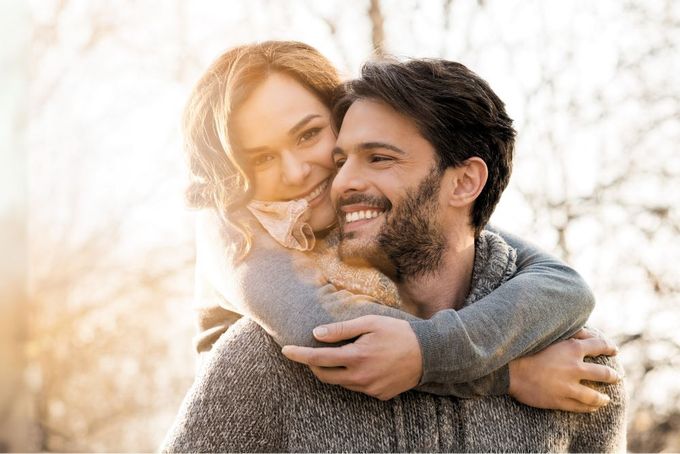 a man holding a woman in his arms