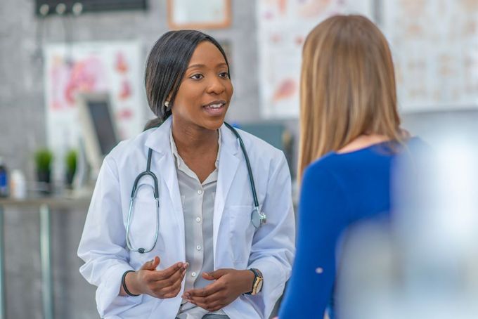 a female doctor talking to a female patient