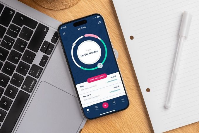 a cell phone sitting on top of a wooden table