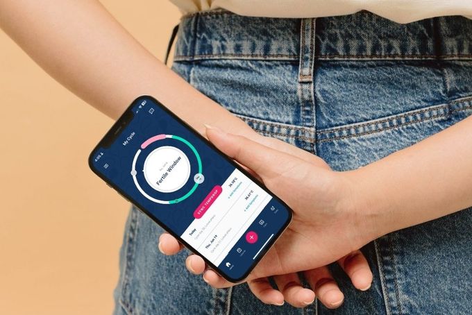 a person holding a cell phone in their hand