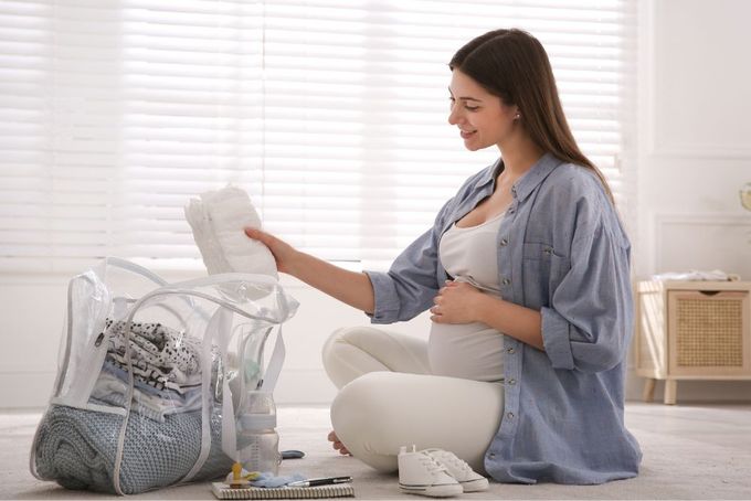 a woman sitting on the floor next to a purse