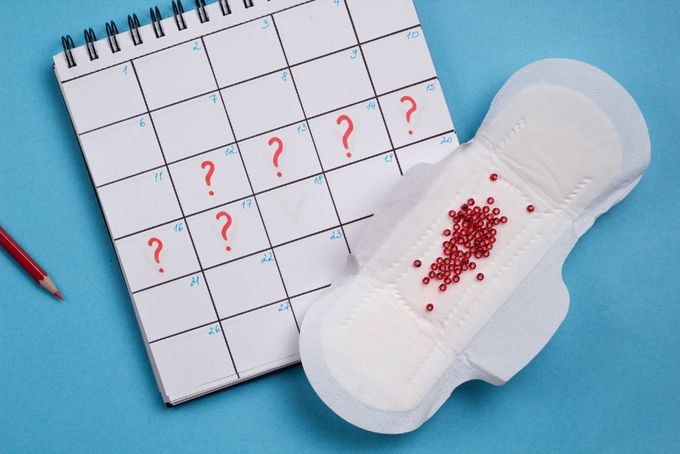 a pair of slippers next to a calendar with question marks