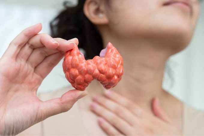 a woman holding up a piece of fruit in front of her face