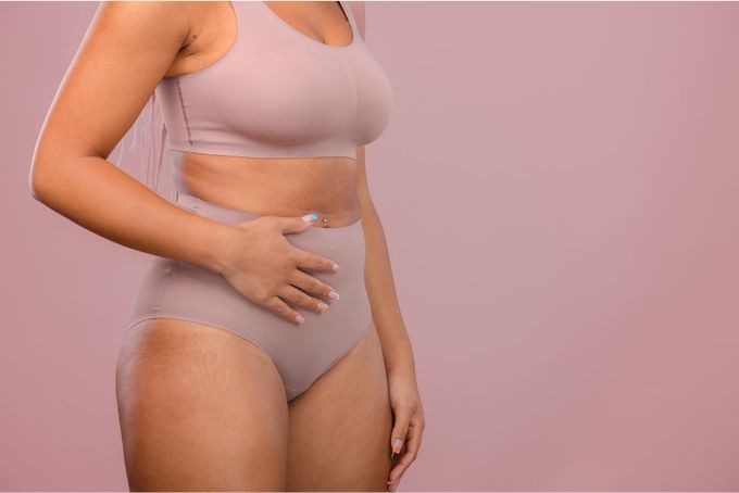 a woman wearing a bra and panties with her stomach exposed