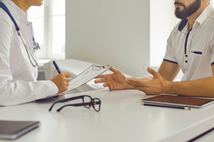 a doctor talking to a patient at a desk