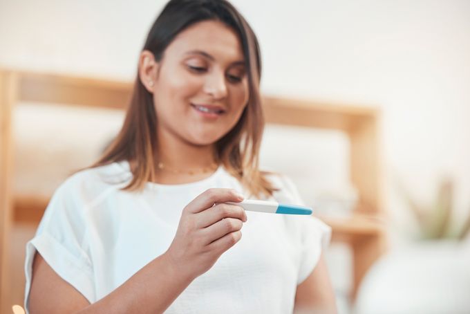 A woman holding a toothbrush in her hand.