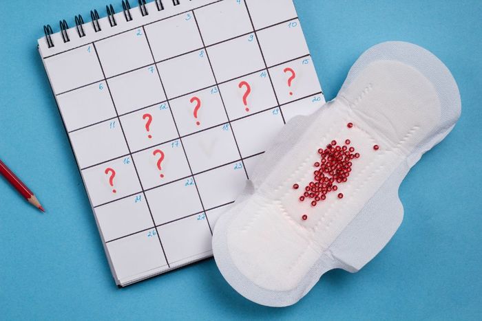a pair of slippers next to a calendar with question marks