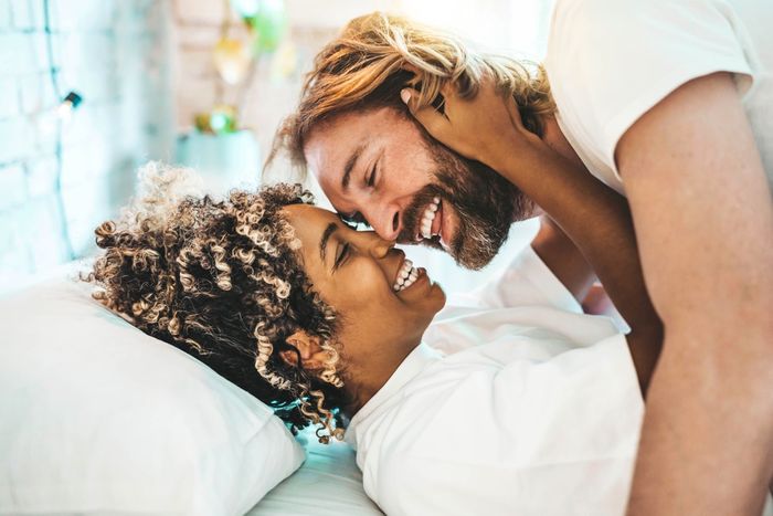 A happy couple in bed together.