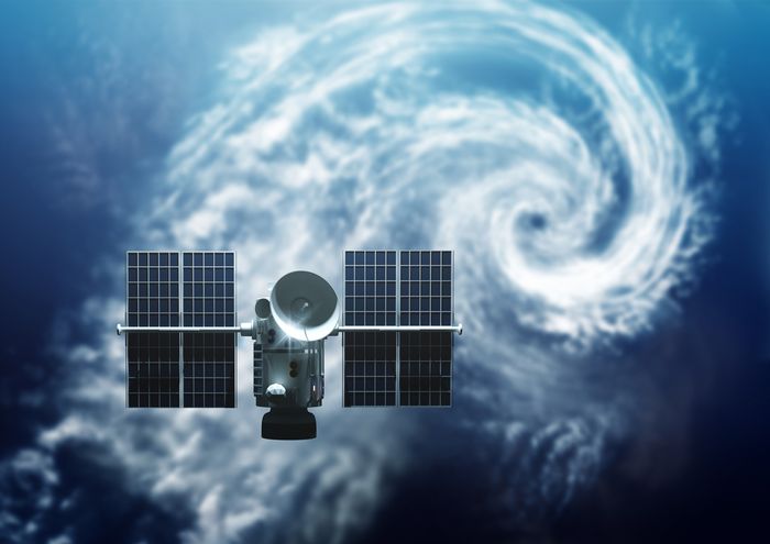 A satellite in the sky over a hurricane measuring weather data