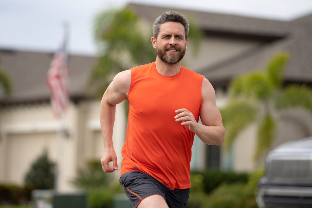 Man doing sprint interval training by running outdoors