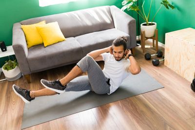 Hispanic man doing crunches for 7-minute workout