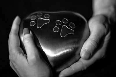 2 people holding an urn for their beloved pet