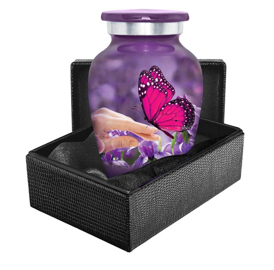 Small purple urn depicting a butterfly in a black leather case