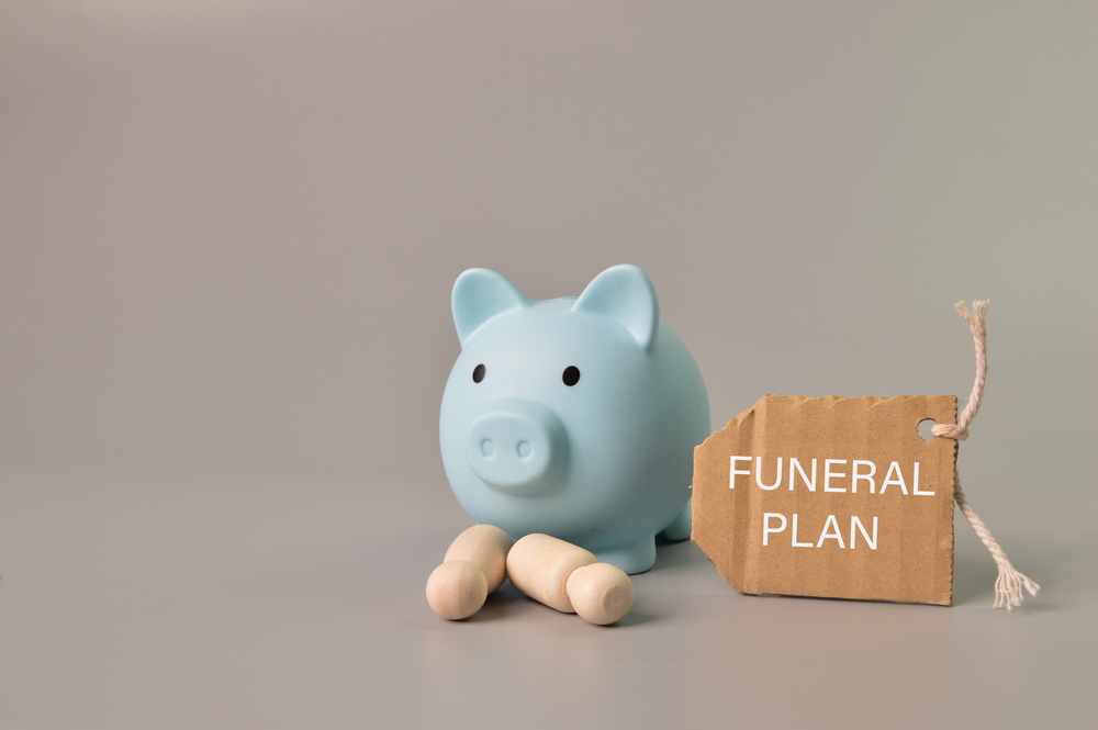 Piggybank with tag that reads "funeral plan"