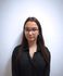 a woman wearing glasses and a black shirt