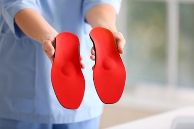 Nurse holding out an insole in each hand