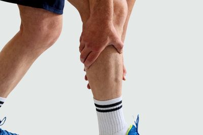 Person holding onto their leg in pain