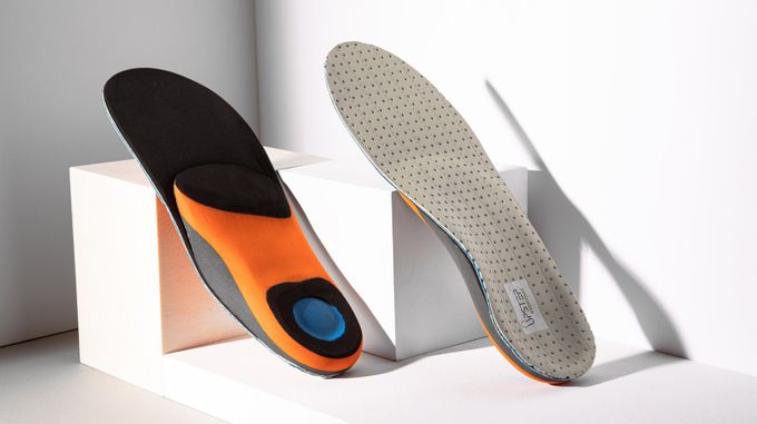 Pair of tennis custom orthotics on display, showcasing both the front and back