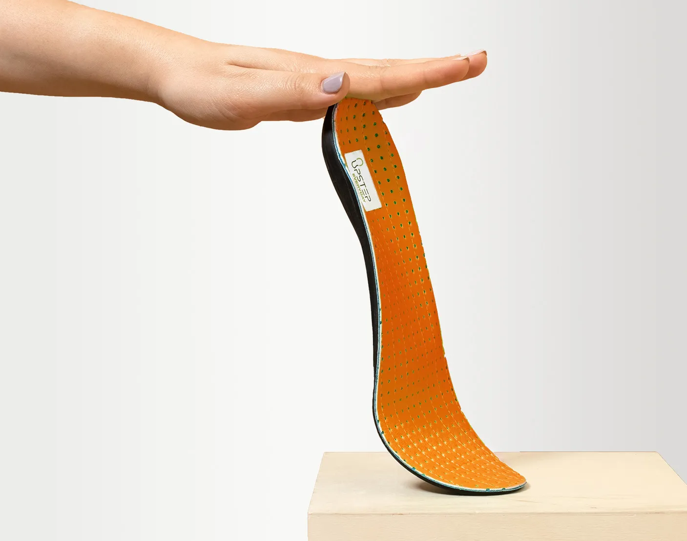 Upstep custom insole for flat feet being presented from the side
