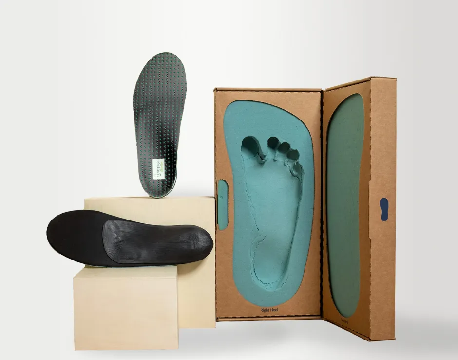 Upstep's On My Feet All Day shoe orthotics presented out of the shipping box, next to the feet impression kit.