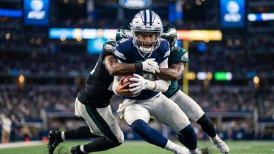 a football player is being tackled by another player