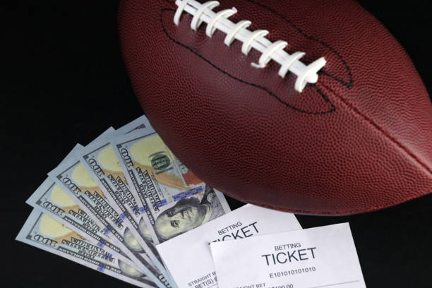 a football sitting on top of a pile of money